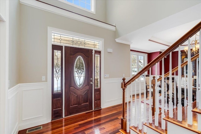 foyer entrance featuring ornamental molding and hardwood / wood-style floors