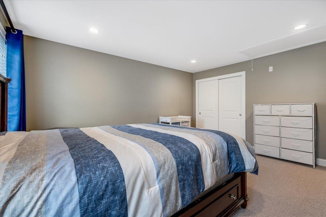 bedroom featuring a closet and light carpet