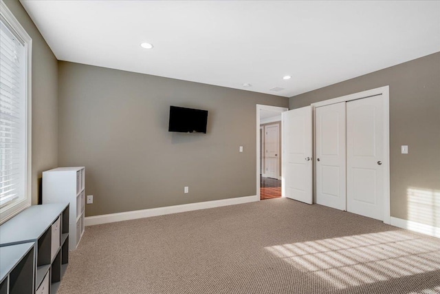 unfurnished bedroom featuring carpet floors and a closet