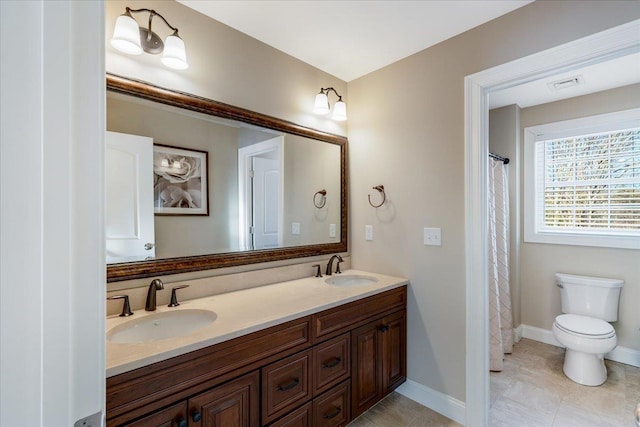 bathroom featuring vanity, tile patterned floors, and toilet