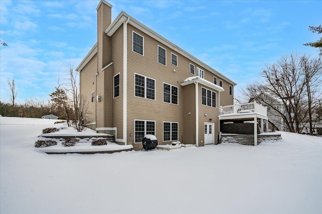 snow covered property featuring a deck