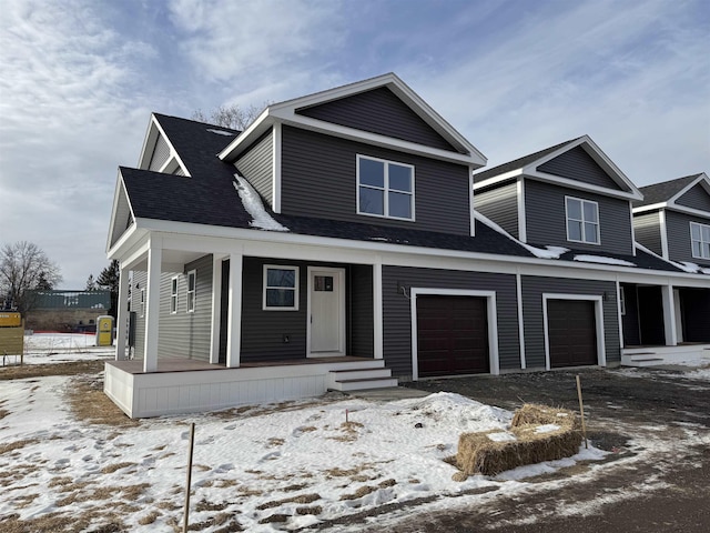 view of front of home featuring a porch, a garage, and a shingled roof