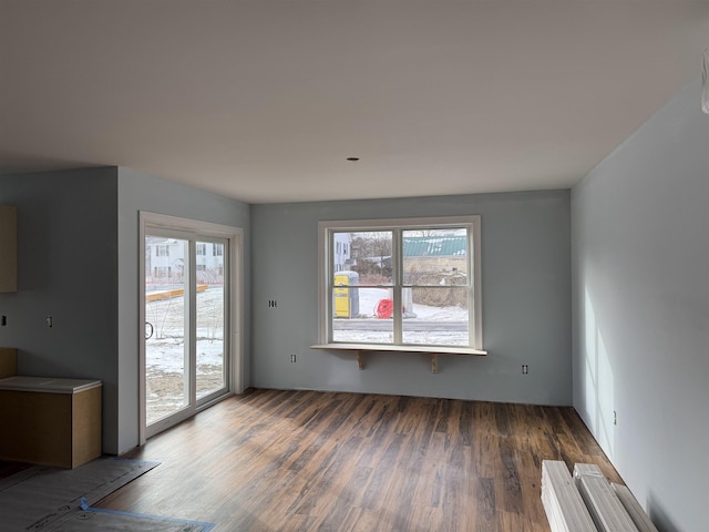 unfurnished living room with dark hardwood / wood-style floors