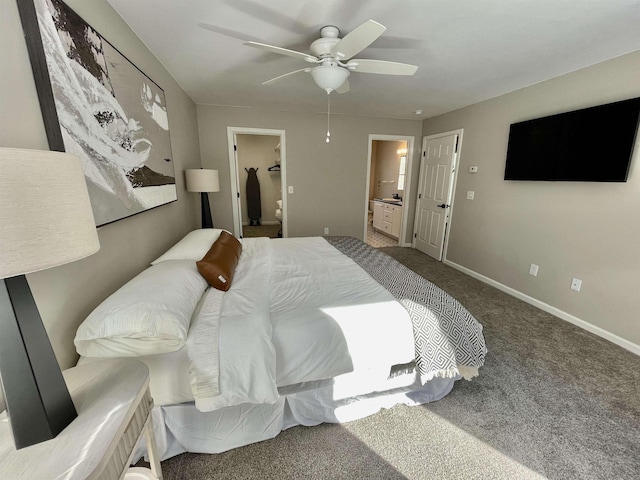 bedroom featuring connected bathroom, carpet, a spacious closet, ceiling fan, and a closet