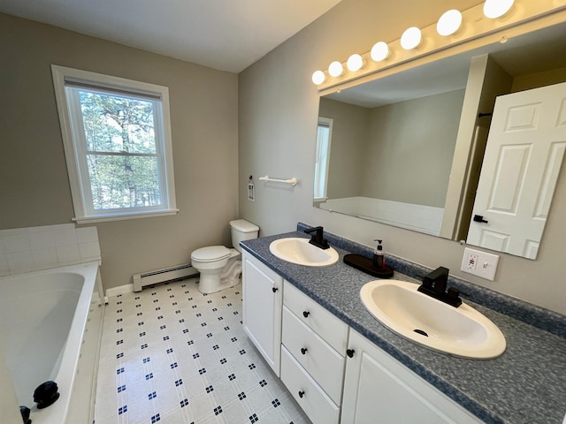 bathroom with vanity, a bathing tub, baseboard heating, and toilet