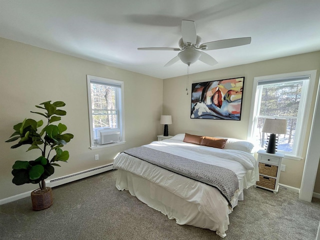 bedroom featuring multiple windows, a baseboard heating unit, light colored carpet, and ceiling fan