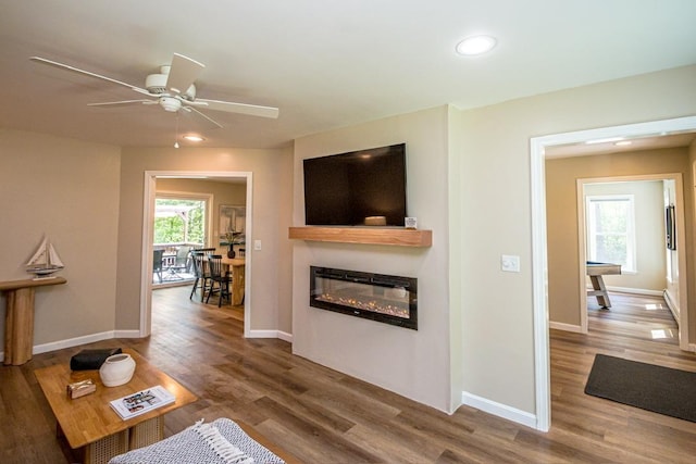 living room featuring hardwood / wood-style flooring, plenty of natural light, and ceiling fan