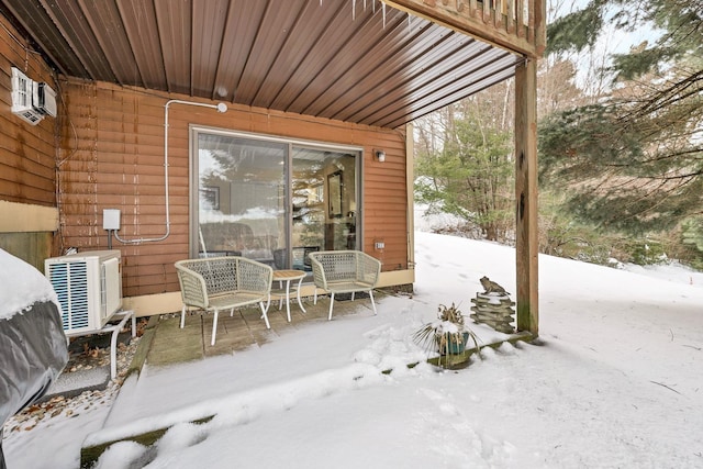 snow covered patio with ac unit