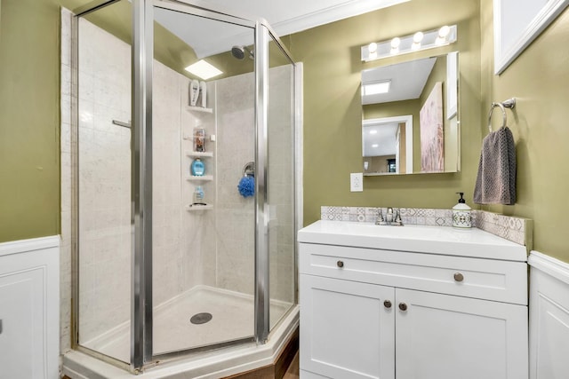 bathroom featuring vanity and a shower with shower door