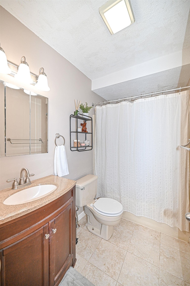 bathroom featuring vanity, tile patterned floors, a textured ceiling, and toilet