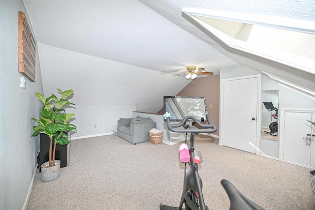 workout room featuring lofted ceiling, carpet floors, a textured ceiling, and ceiling fan