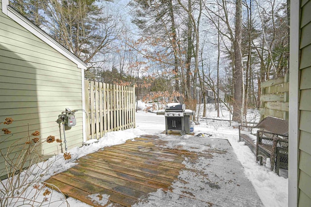 snow covered deck featuring a grill