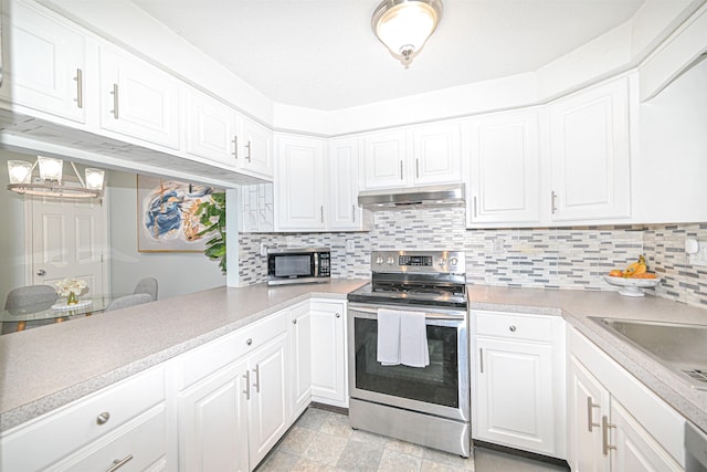 kitchen with white cabinetry, decorative backsplash, kitchen peninsula, and appliances with stainless steel finishes