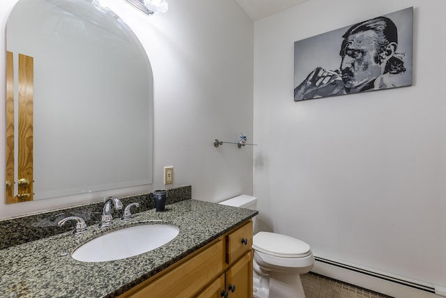 bathroom featuring vanity, toilet, and baseboard heating