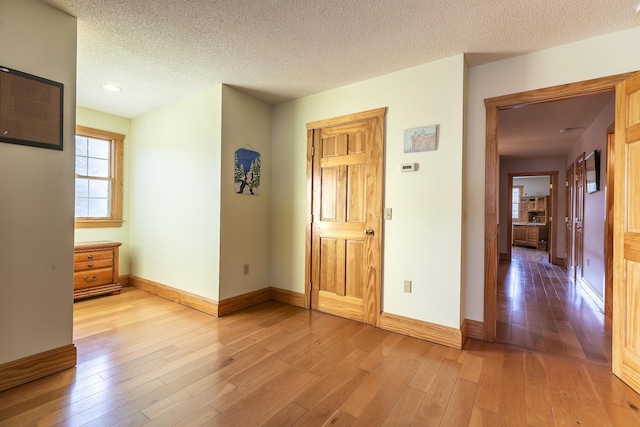 empty room featuring hardwood / wood-style floors and a textured ceiling