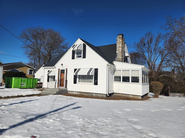 view of front of house featuring a sunroom