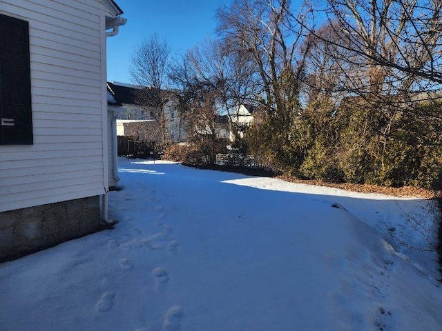 view of yard layered in snow