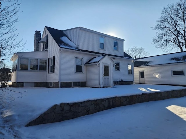 view of snow covered rear of property