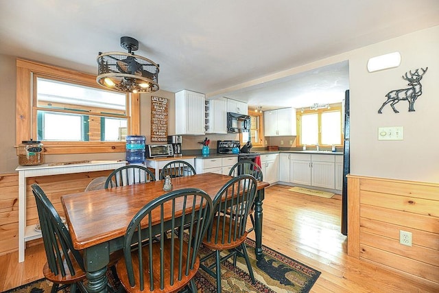 dining area with sink and light hardwood / wood-style flooring