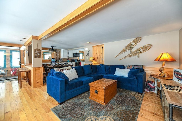 living room with beam ceiling and light hardwood / wood-style flooring