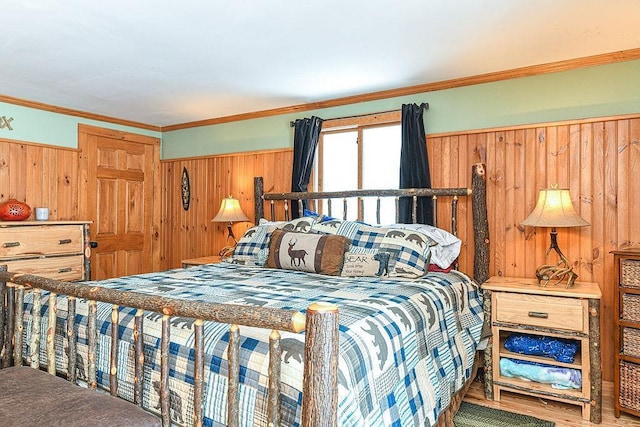 bedroom with crown molding and wooden walls