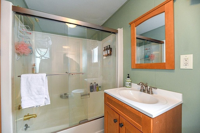 bathroom featuring vanity and bath / shower combo with glass door