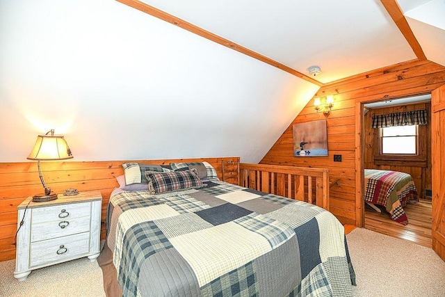 carpeted bedroom featuring lofted ceiling and wood walls