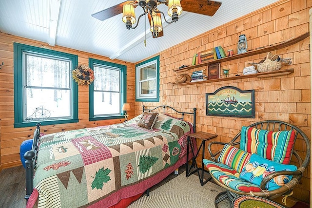 bedroom with wood-type flooring and wood walls