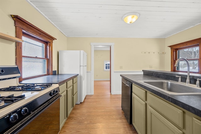 kitchen with black dishwasher, sink, range with gas cooktop, and cream cabinetry