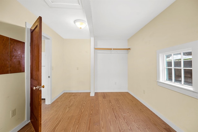 unfurnished bedroom with light hardwood / wood-style floors and a closet