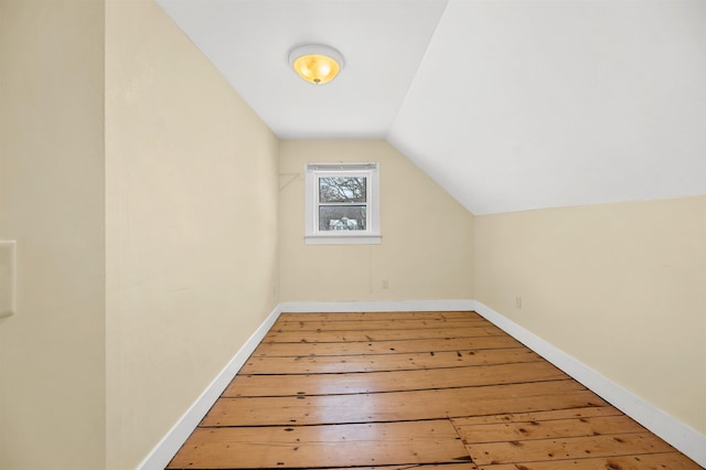 bonus room with lofted ceiling and hardwood / wood-style floors