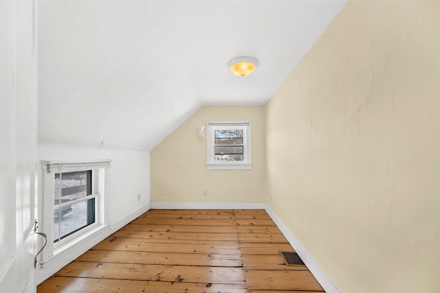 bonus room with vaulted ceiling and light hardwood / wood-style floors