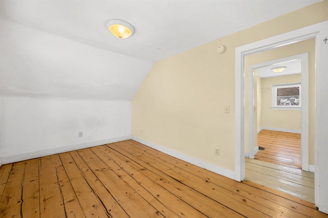 bonus room with lofted ceiling and wood-type flooring