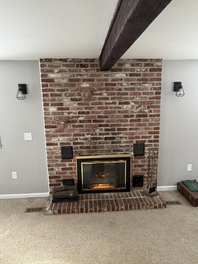 interior details with carpet, beam ceiling, and a brick fireplace