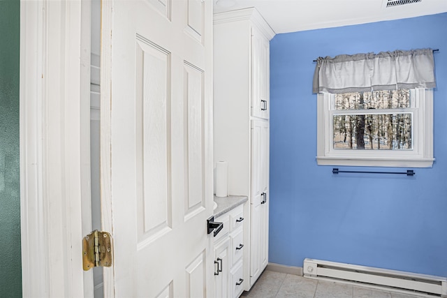 interior space featuring a baseboard radiator and light tile patterned flooring