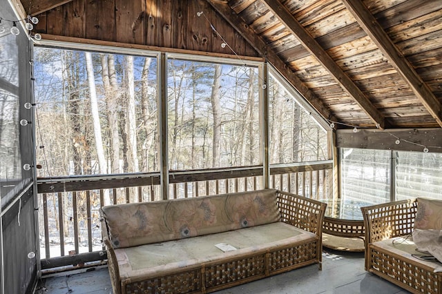 unfurnished sunroom with vaulted ceiling, a healthy amount of sunlight, and wood ceiling