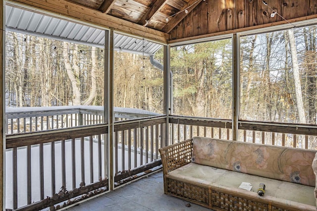 unfurnished sunroom featuring vaulted ceiling