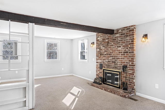 unfurnished living room with carpet flooring, beam ceiling, and a brick fireplace