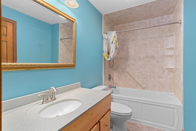 full bathroom featuring vanity, tiled shower / bath combo, and toilet