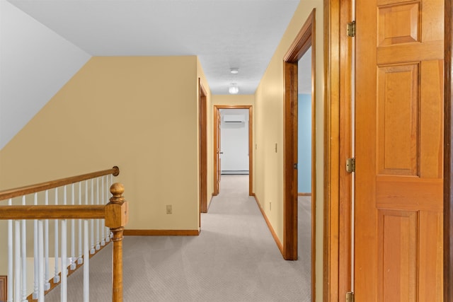 corridor with light carpet and baseboard heating