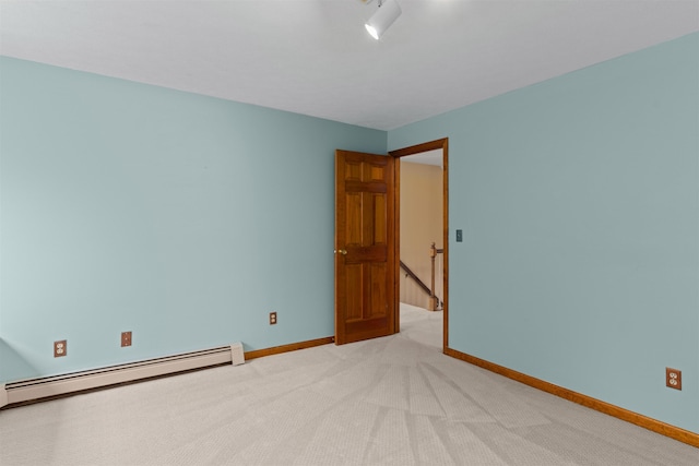 carpeted spare room with a baseboard radiator