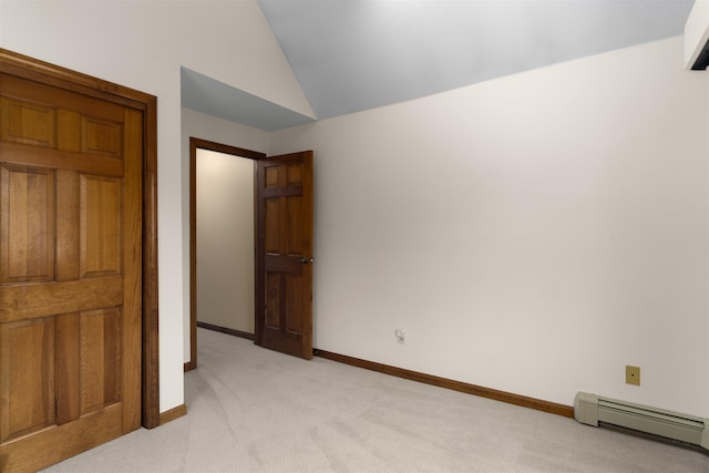 unfurnished bedroom featuring lofted ceiling, light carpet, and baseboard heating