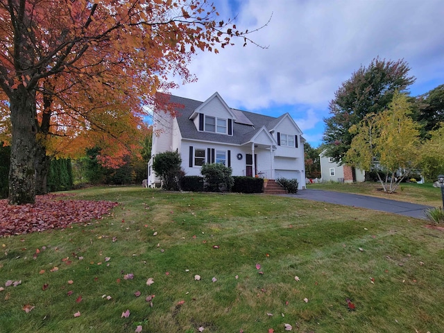 view of front of property with a garage and a front lawn