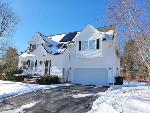 view of front of house with a garage and solar panels