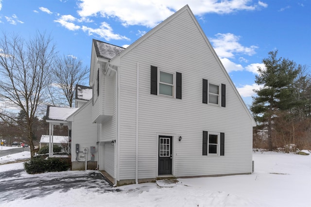 snow covered house with a garage