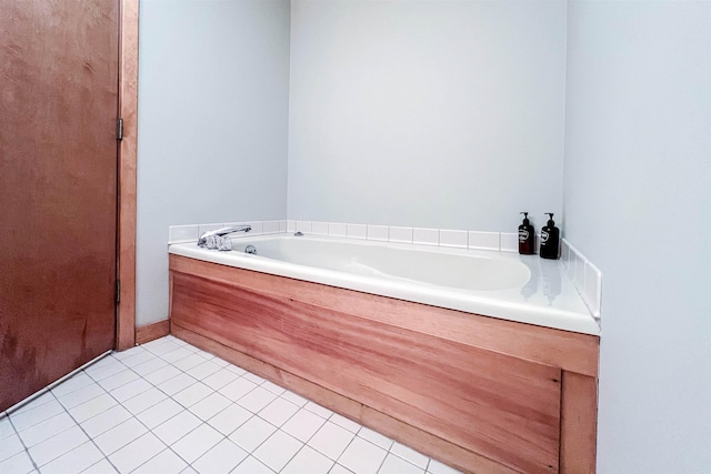 bathroom featuring tile patterned floors and a tub to relax in