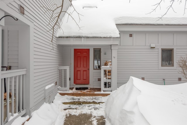 view of snow covered property entrance