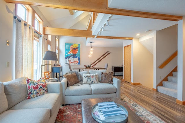 living room featuring hardwood / wood-style flooring, vaulted ceiling with beams, and track lighting