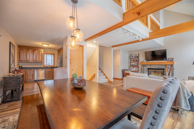 dining room featuring sink, a fireplace, and light hardwood / wood-style floors