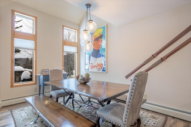 dining space with a baseboard radiator and light wood-type flooring